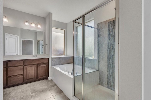 bathroom with independent shower and bath, tile patterned flooring, and vanity