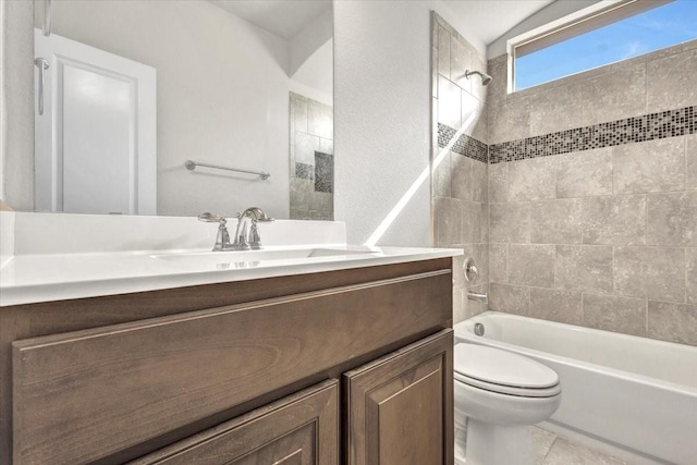 full bathroom featuring toilet, tile patterned flooring, tiled shower / bath, and vanity