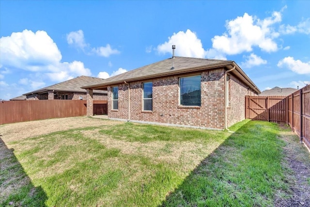 rear view of property with a lawn