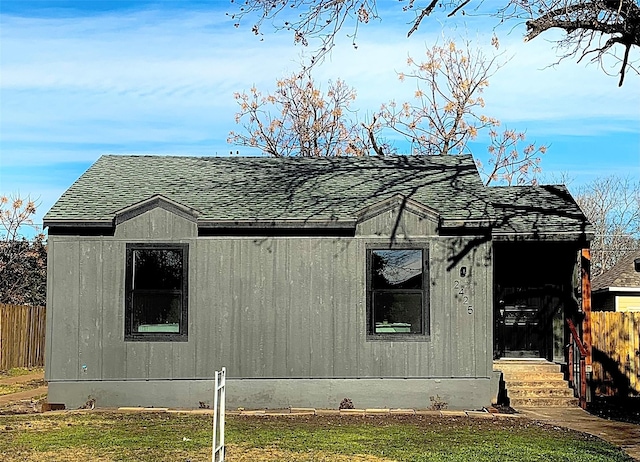 view of side of home with a yard