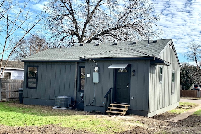 back of property featuring a yard and central air condition unit