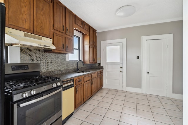 kitchen with dishwashing machine, stainless steel gas stove, sink, decorative backsplash, and light tile patterned flooring