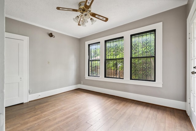 unfurnished room featuring ceiling fan, a textured ceiling, and hardwood / wood-style flooring