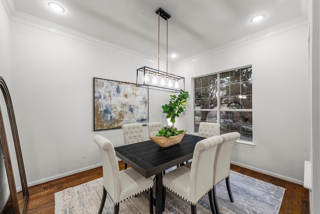 dining space featuring ornamental molding and dark hardwood / wood-style floors