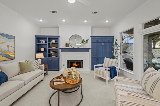 carpeted living room with crown molding and ceiling fan