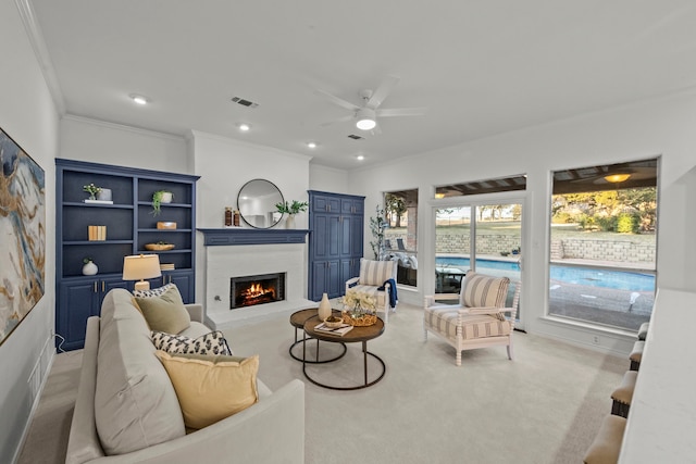 living room with ornamental molding, light colored carpet, and ceiling fan