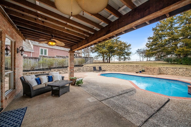 view of pool featuring ceiling fan, an outdoor living space, and a patio