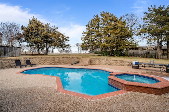 view of pool featuring a patio and an in ground hot tub