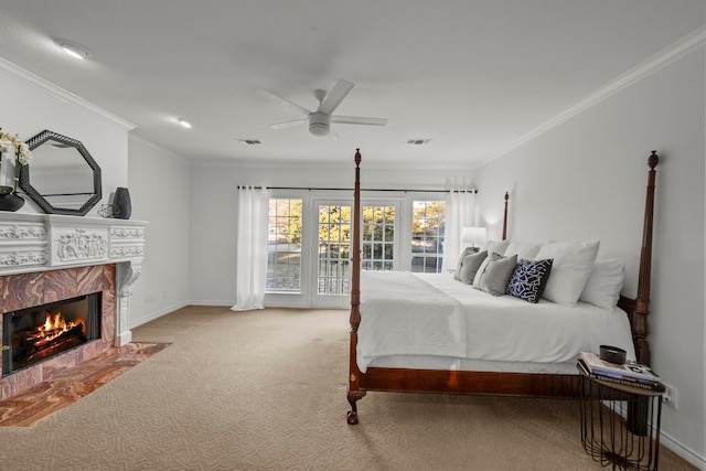 carpeted bedroom featuring a fireplace, crown molding, access to outside, and ceiling fan