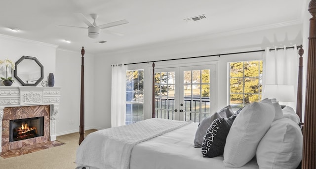 bedroom with ceiling fan, access to exterior, a high end fireplace, ornamental molding, and french doors