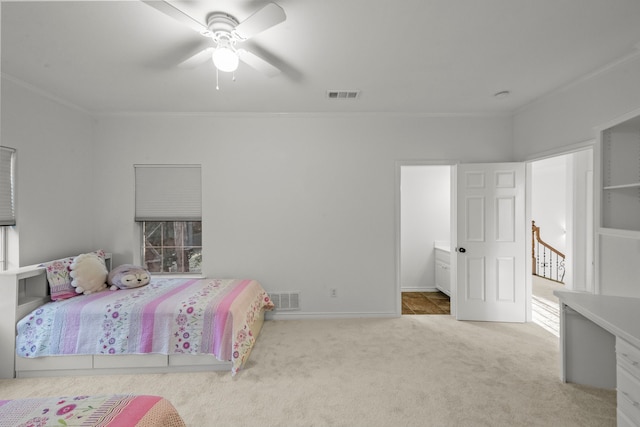 bedroom featuring ornamental molding, light colored carpet, and ceiling fan