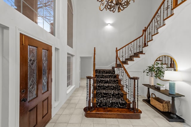 foyer featuring a high ceiling and a notable chandelier