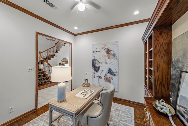 home office featuring crown molding, light hardwood / wood-style floors, and ceiling fan