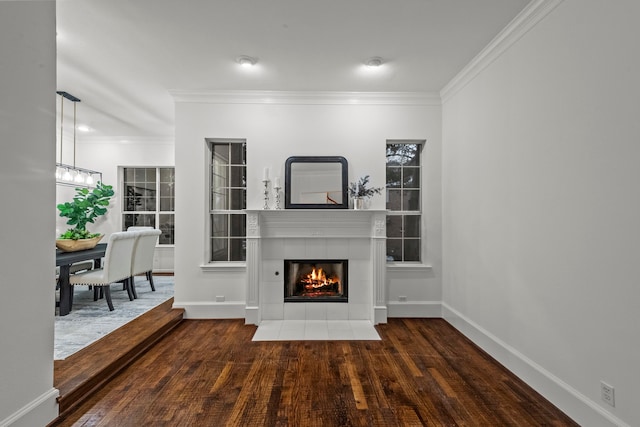 unfurnished living room with a fireplace, dark wood-type flooring, and ornamental molding