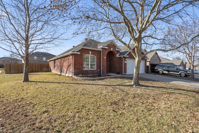 view of front of property featuring a front yard and a garage