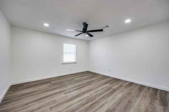 empty room featuring ceiling fan and hardwood / wood-style floors