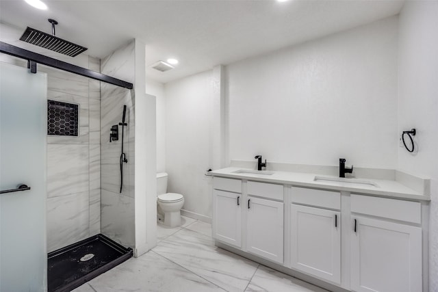 bathroom with toilet, vanity, and a shower with door