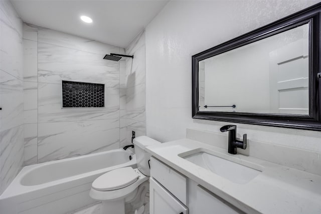 full bathroom featuring toilet, vanity, and tiled shower / bath