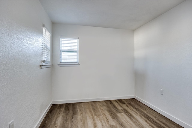 spare room with wood-type flooring