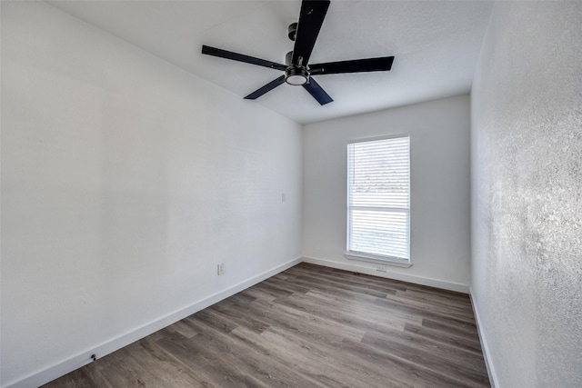 empty room with ceiling fan and wood-type flooring