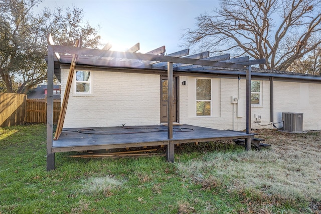 back of property with central AC, a pergola, and a wooden deck