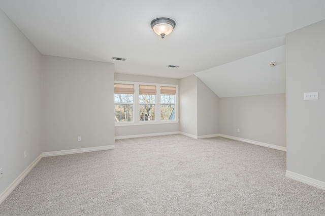 additional living space with lofted ceiling and carpet floors