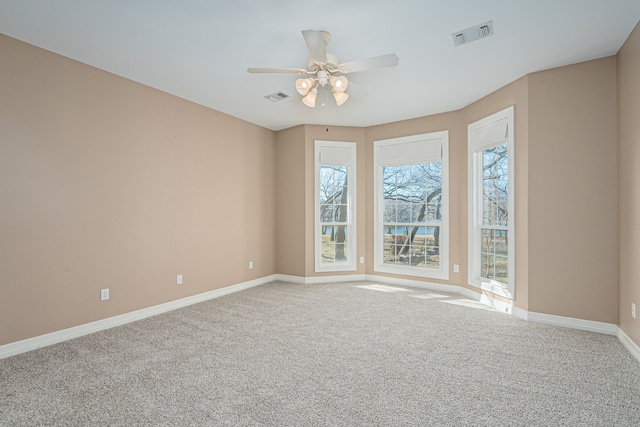 carpeted empty room featuring ceiling fan