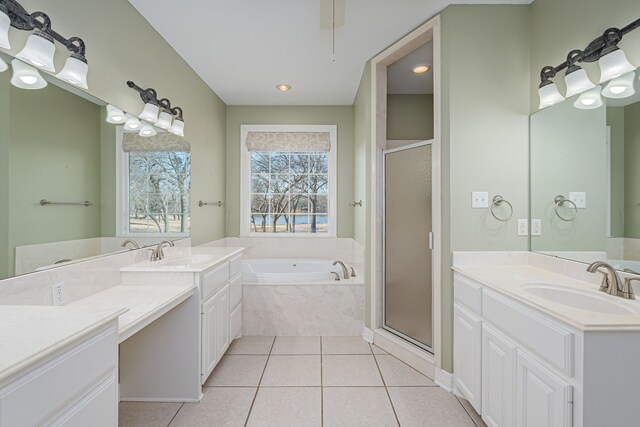 bathroom with tile patterned floors, separate shower and tub, and vanity