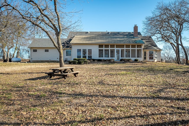 back of house featuring a sunroom and a yard