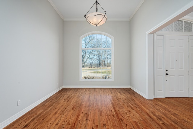 unfurnished room featuring wood-type flooring and ornamental molding