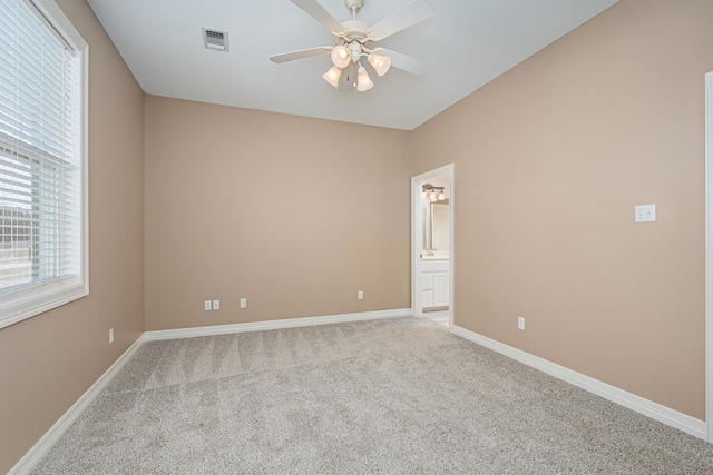 unfurnished room featuring ceiling fan and light carpet