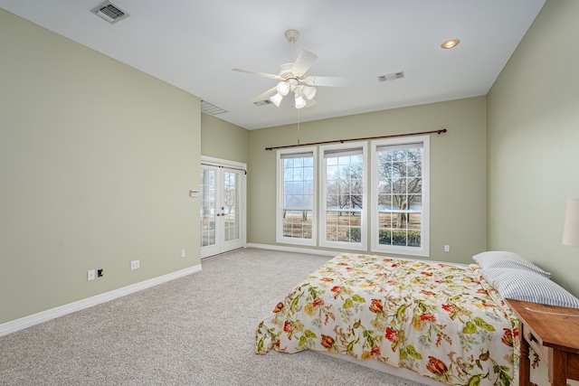 bedroom featuring light carpet, access to exterior, ceiling fan, and french doors