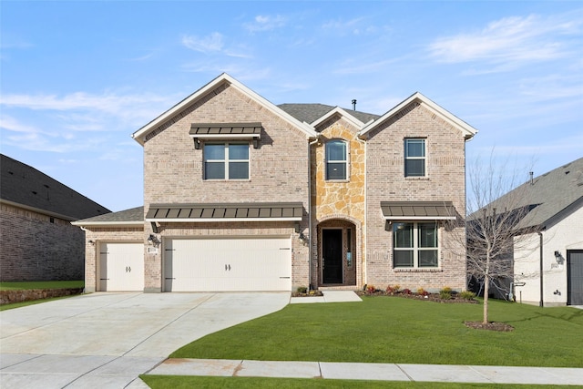 view of front of property featuring a garage and a front lawn