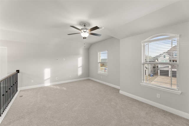 carpeted empty room with lofted ceiling and ceiling fan