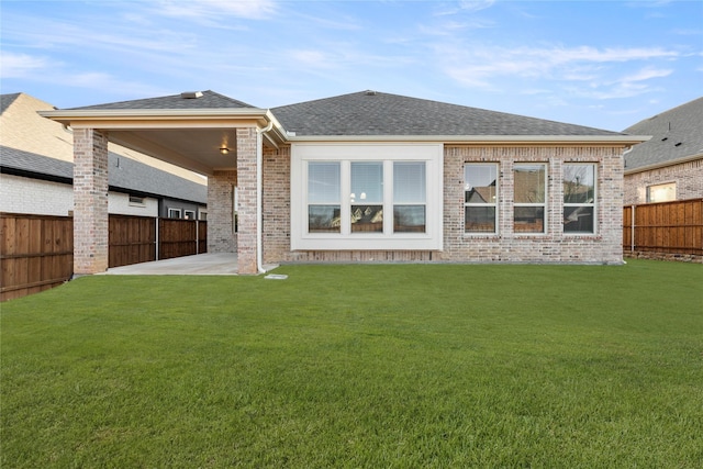 back of property with a patio and a lawn