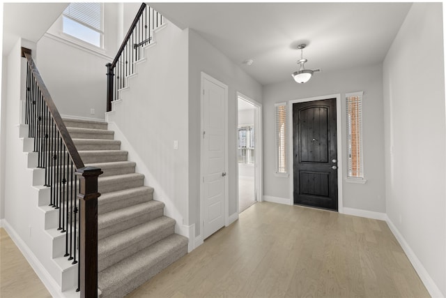 foyer entrance with light hardwood / wood-style flooring