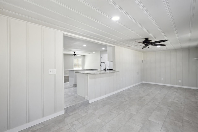 kitchen featuring ceiling fan, white cabinetry, kitchen peninsula, and sink