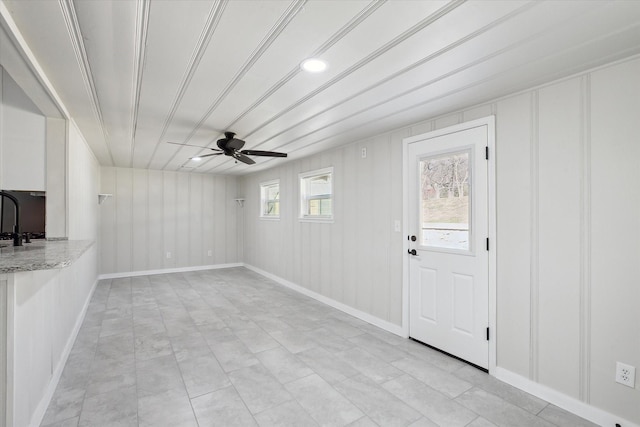 unfurnished living room with ceiling fan and sink