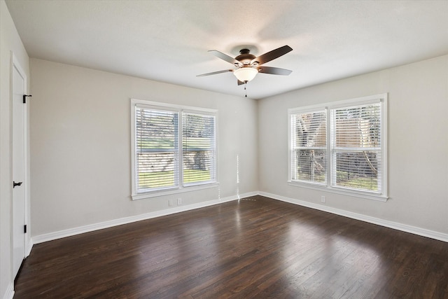 unfurnished room with dark wood-type flooring, a healthy amount of sunlight, and ceiling fan