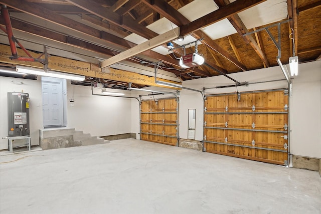 garage featuring water heater and a garage door opener