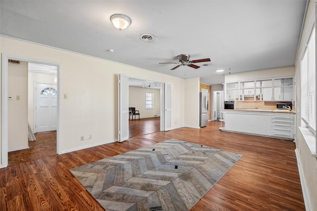 living room with ceiling fan and dark hardwood / wood-style flooring