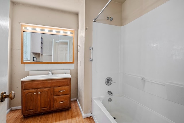 bathroom with wood-type flooring, shower / tub combination, and vanity