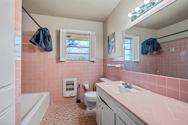 full bathroom featuring tile patterned flooring, vanity, tile walls, toilet, and heating unit