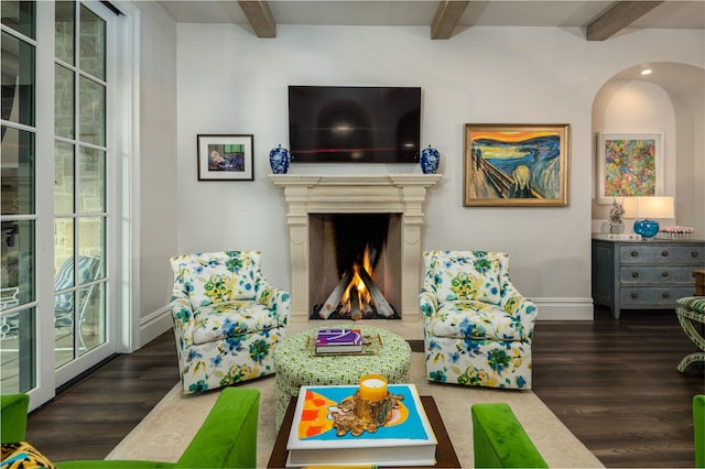 recreation room featuring beam ceiling and dark hardwood / wood-style floors