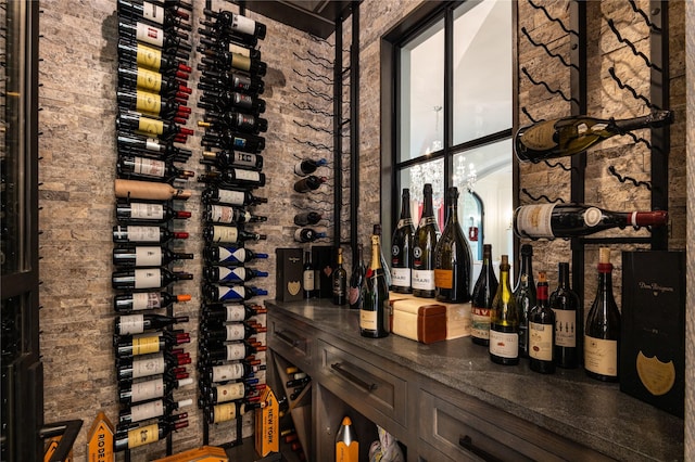 wine area featuring brick wall