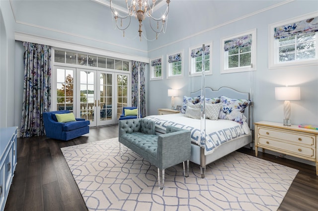 bedroom featuring access to outside, french doors, dark hardwood / wood-style flooring, and an inviting chandelier