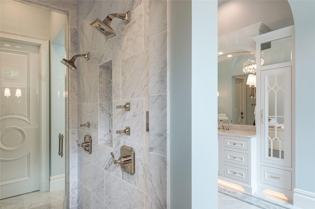 bathroom with vanity and a shower with door