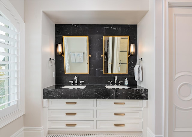 bathroom with vanity and tasteful backsplash