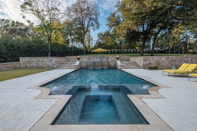 view of swimming pool with an in ground hot tub and a patio area