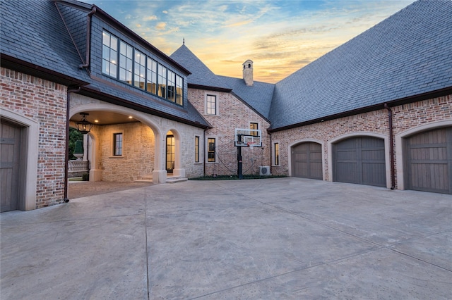 property exterior at dusk featuring a garage